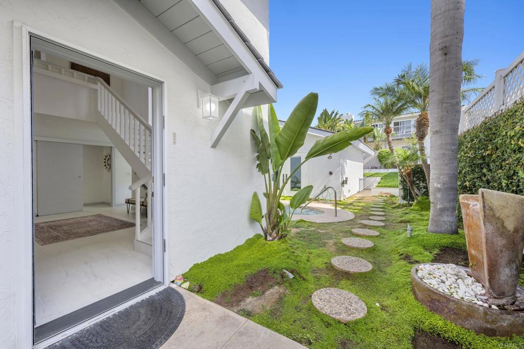 1561 Neptune Avenue Encinitas, CA 92024 - Photo 24 of 30 a vase of flowers sitting in front of a door