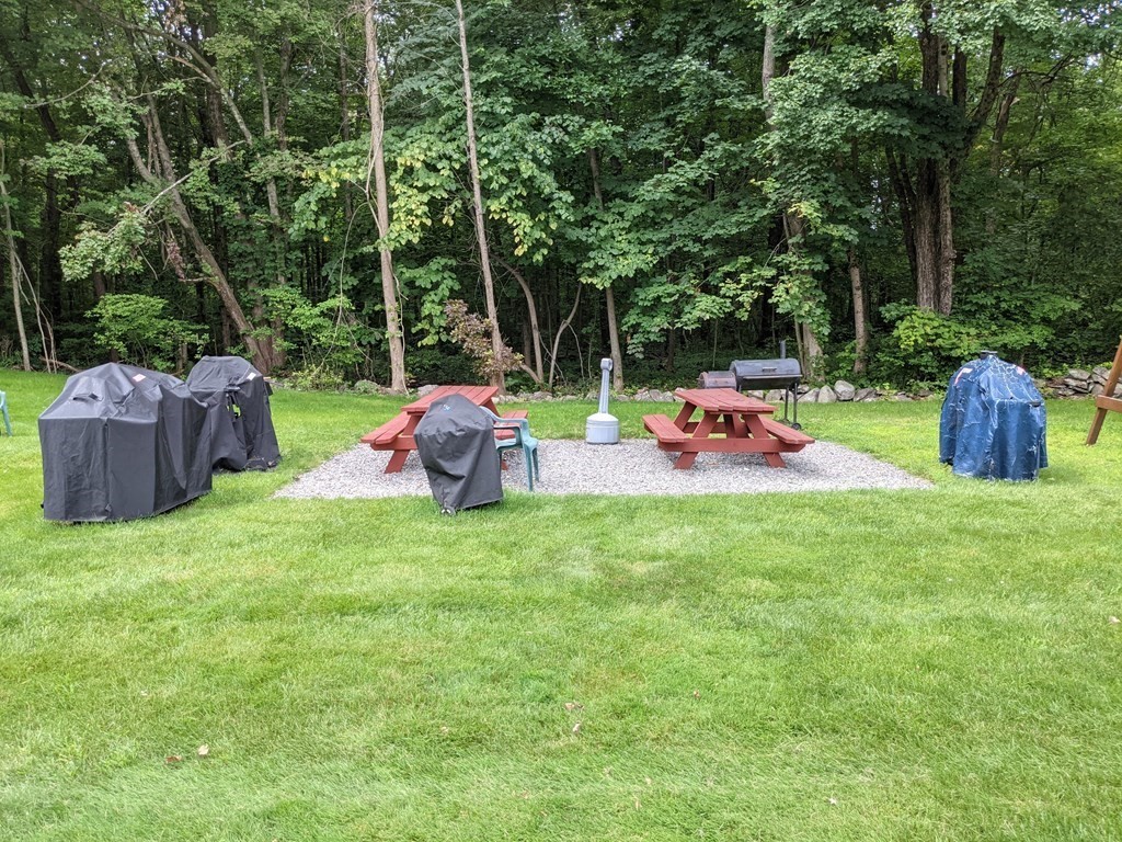 72 Leonard Road, Unit 72 Boxborough, MA 01719 - Photo 18 of 25 a backyard of a house with table and chairs