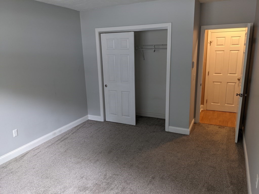 72 Leonard Road, Unit 72 Boxborough, MA 01719 - Photo 9 of 25 an empty room with windows and closet