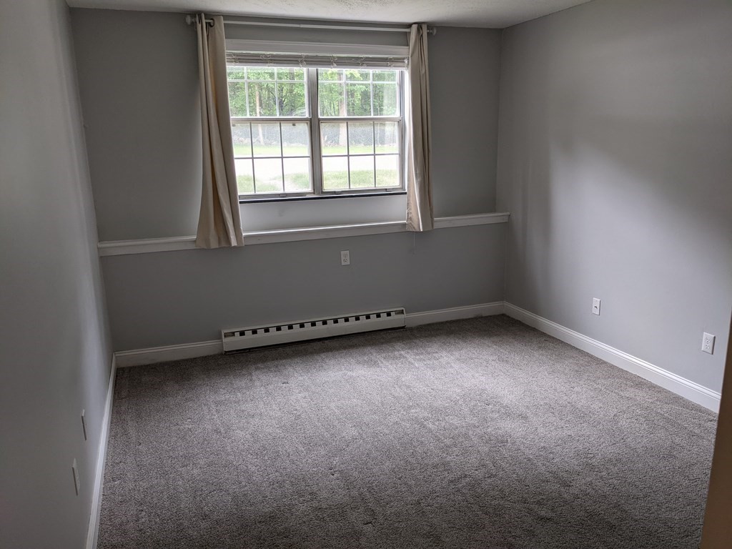 72 Leonard Road, Unit 72 Boxborough, MA 01719 - Photo 10 of 25 an empty room with a window