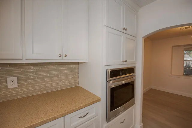 a kitchen with stainless steel appliances a sink stove top oven and cabinets