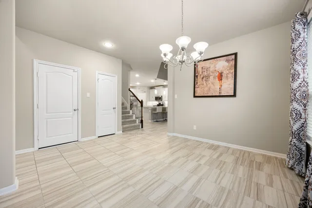 a view of an empty room with a ceiling fan