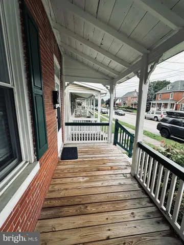 a view of a balcony with wooden floor