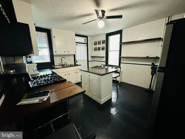 a kitchen with appliances cabinets and a table