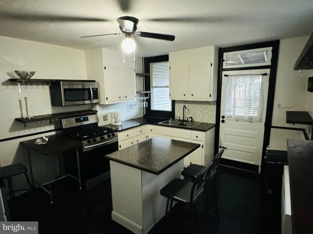 a kitchen with a sink stove and refrigerator