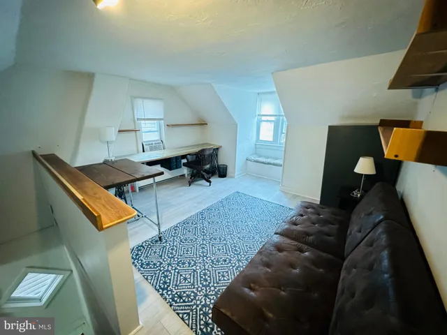 a living room with furniture and a rug