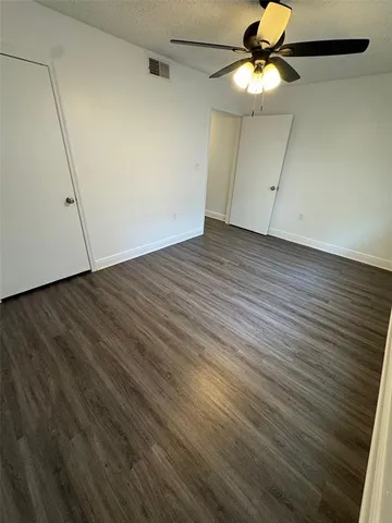 a view of a room with wooden floor