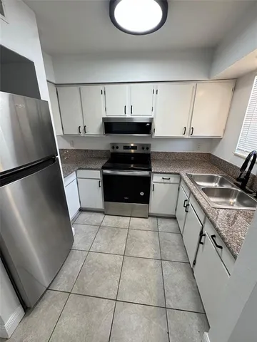 a kitchen with stainless steel appliances granite countertop a sink and a stove