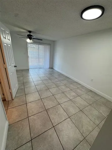 a view of a livingroom with white floor and a window