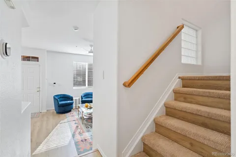 a view of hallway with stairs and wooden floor