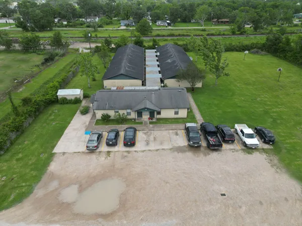 an aerial view of a house with garden space and street view