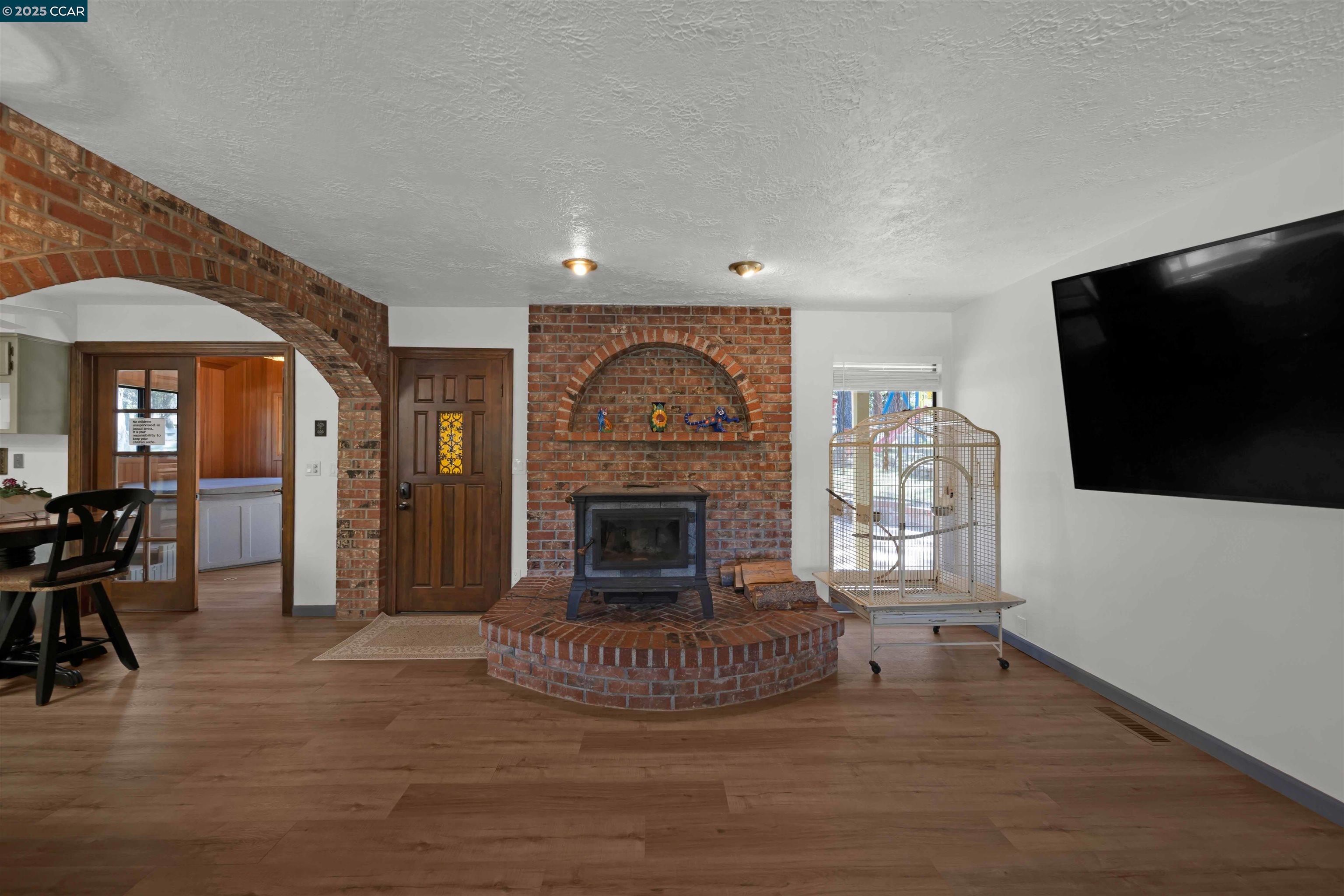 1324 Alves Road Weed, CA 96094 - Photo 15 of 58 a living room with furniture a flat screen tv and a fireplace