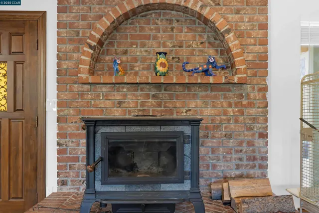 a living room with furniture a fireplace and wooden floor