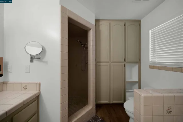 a spacious bedroom with a bed and a chandelier