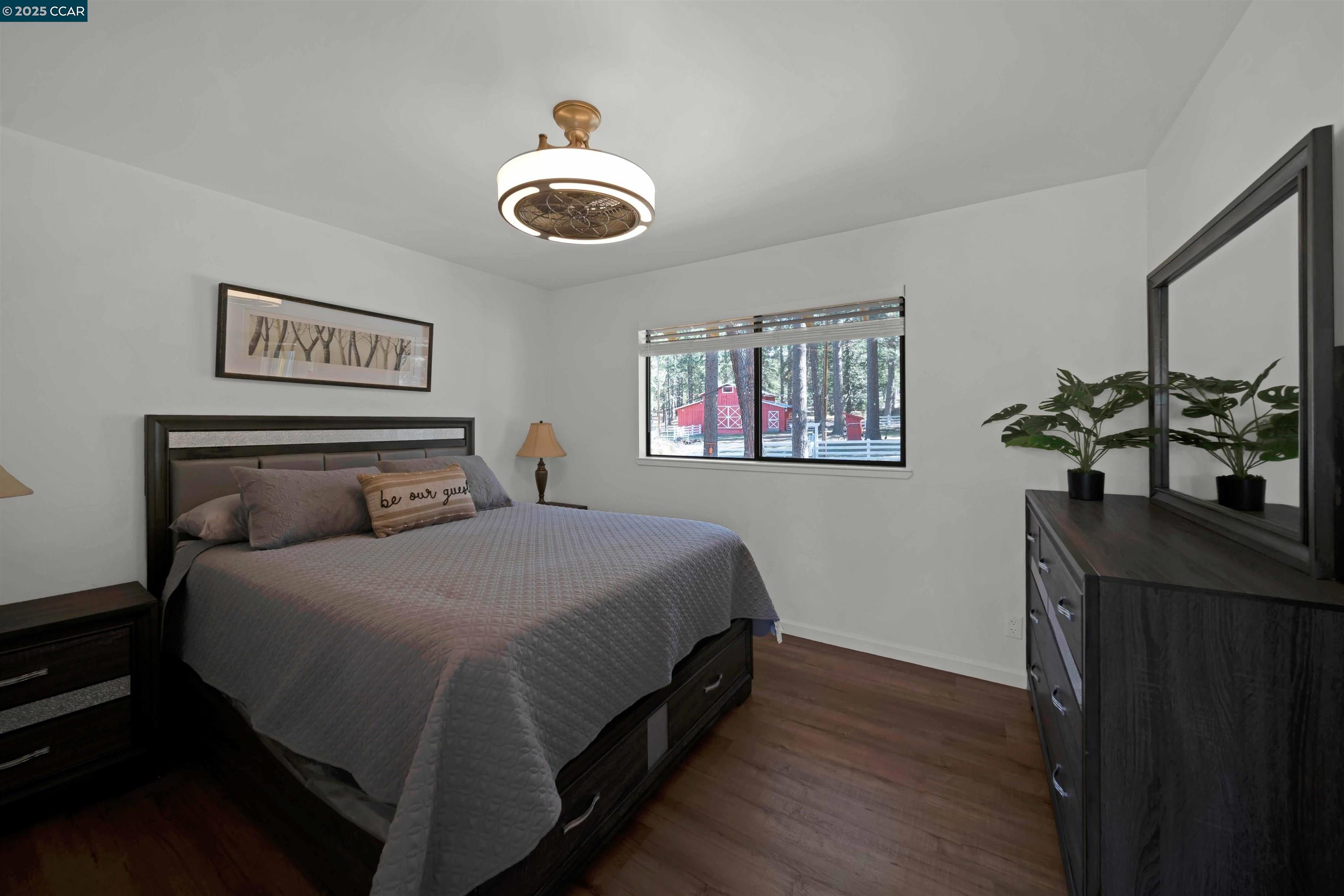 1324 Alves Road Weed, CA 96094 - Photo 29 of 58 a bedroom with a bed and wooden floor