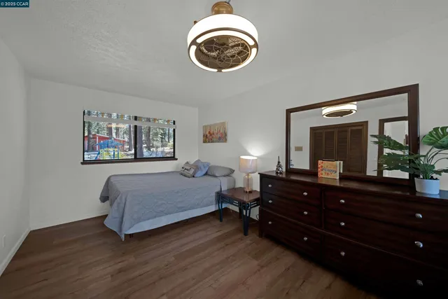 a bathroom with a granite countertop double vanity sink and a mirror