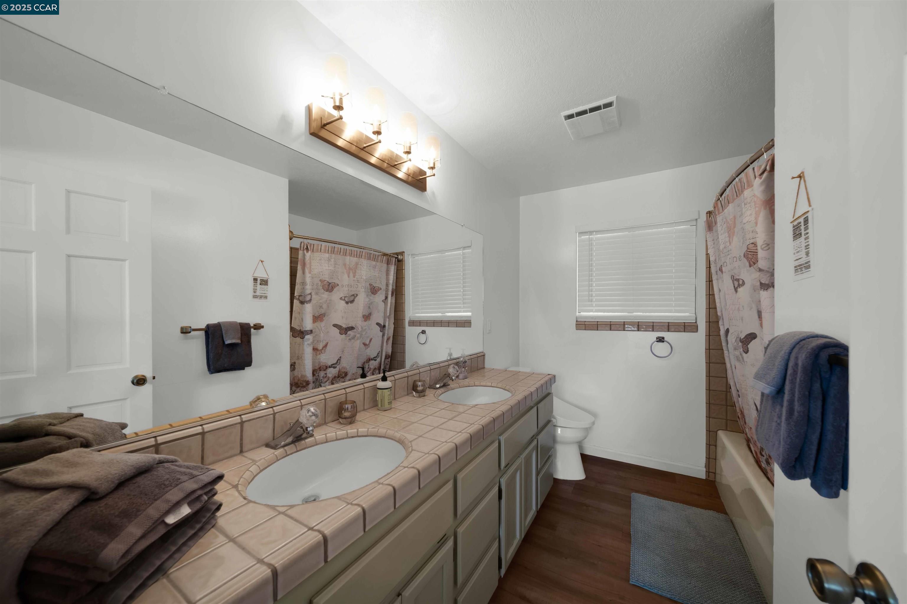1324 Alves Road Weed, CA 96094 - Photo 34 of 58 a bathroom with a granite countertop double vanity sink and a mirror