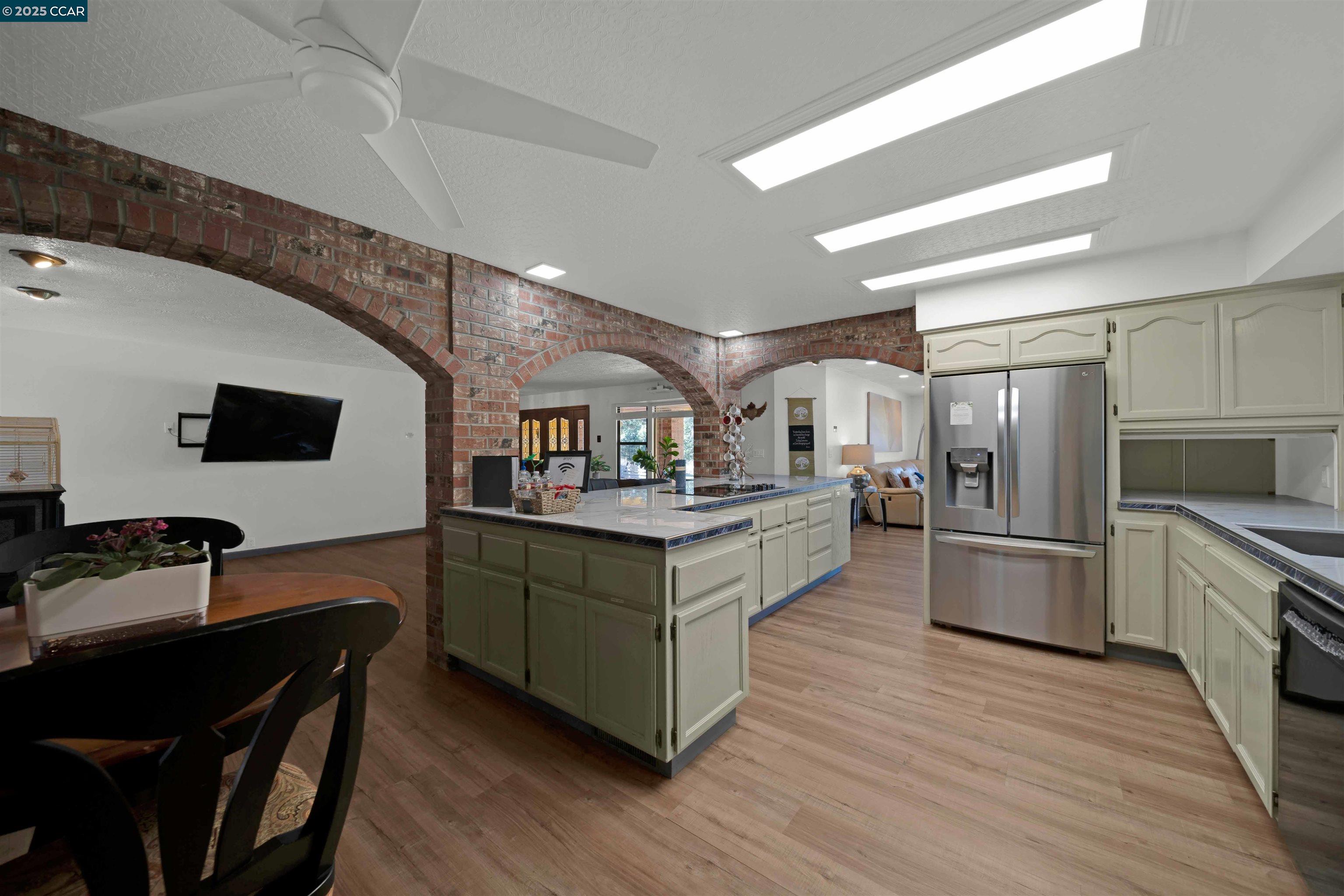 1324 Alves Road Weed, CA 96094 - Photo 9 of 58 a kitchen with stainless steel appliances kitchen island hardwood floor sink stove dining table and chairs