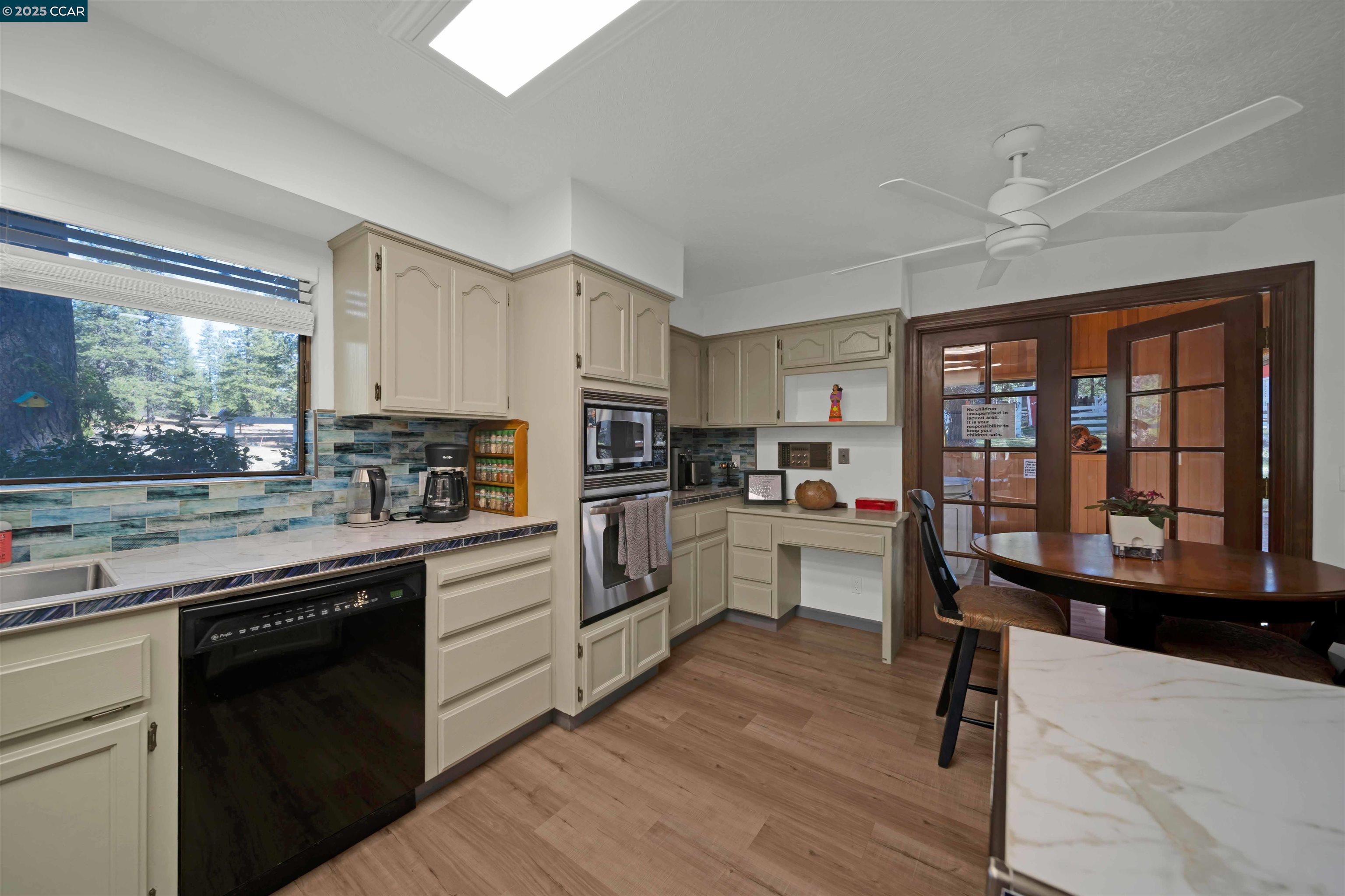 1324 Alves Road Weed, CA 96094 - Photo 10 of 58 a kitchen with white cabinets and appliances
