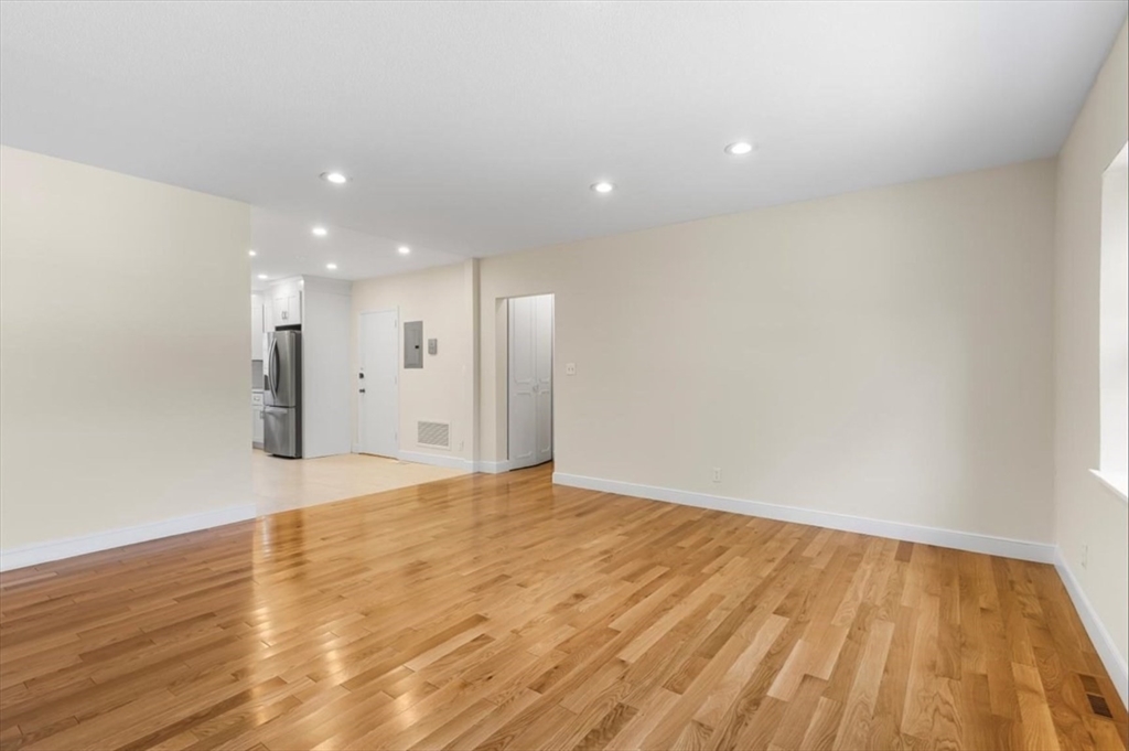 30 Lake Shore Court, Unit 1 Boston, MA 02135 - Photo 3 of 15 a view of an empty room with wooden floor