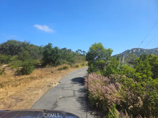 a view of a lake with beach and green space