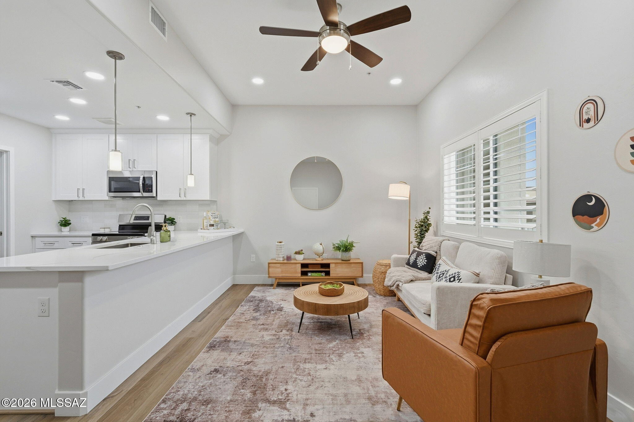 2020 East River Road, Unit 201 Tucson, AZ 85718 - Photo 2 of 10 a living room with furniture kitchen and a window
