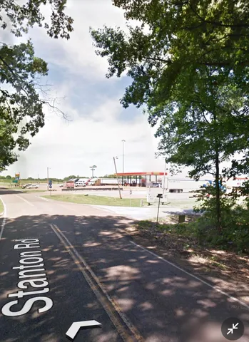a view of a street with a tree