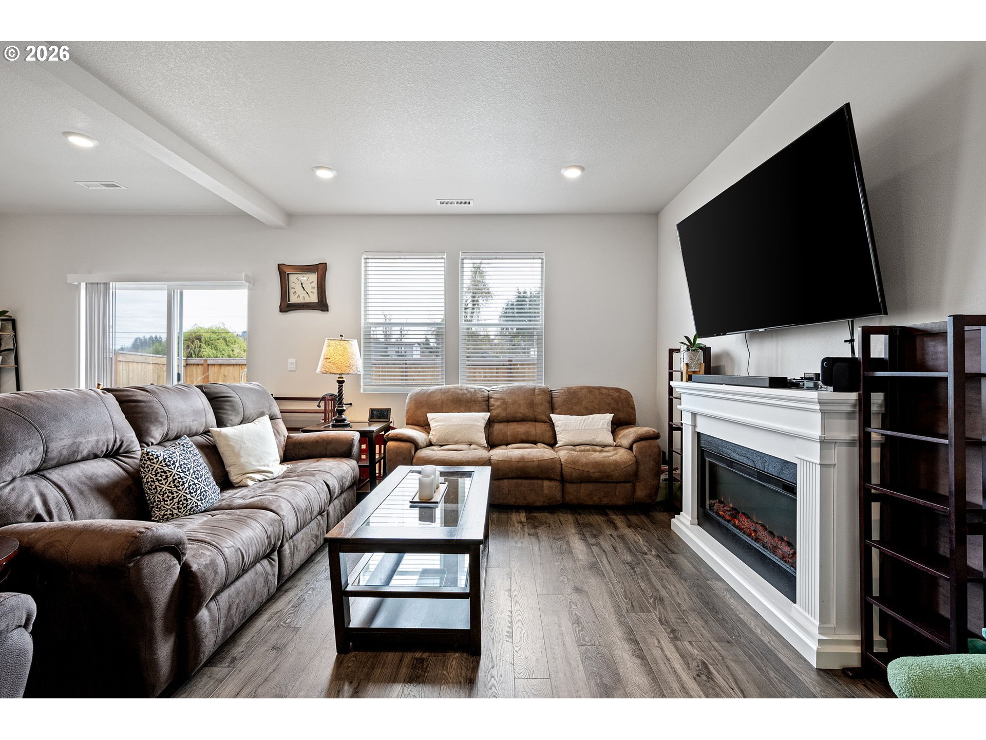 2259 30th Place Springfield, OR 97477 - Photo 13 of 48 a living room with furniture a flat screen tv and a fireplace