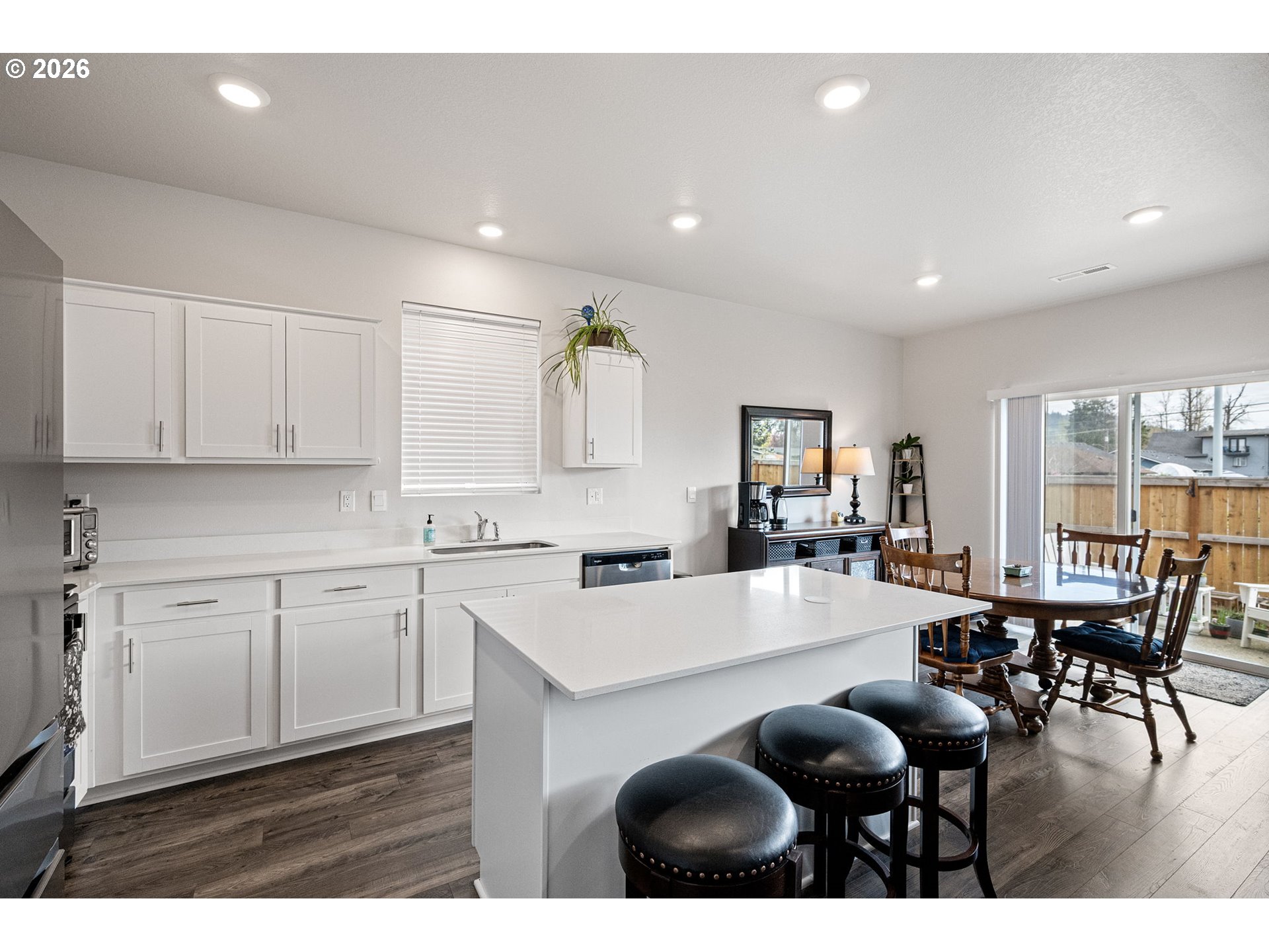 2259 30th Place Springfield, OR 97477 - Photo 17 of 48 a open kitchen with granite countertop a stove a sink a dining table and chairs