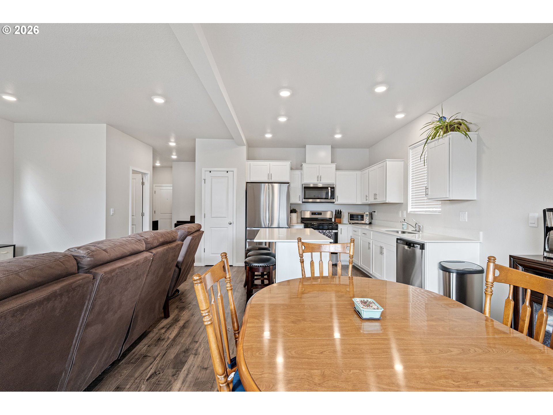 2259 30th Place Springfield, OR 97477 - Photo 21 of 48 a living room with stainless steel appliances kitchen island a table chairs in it and a kitchen view