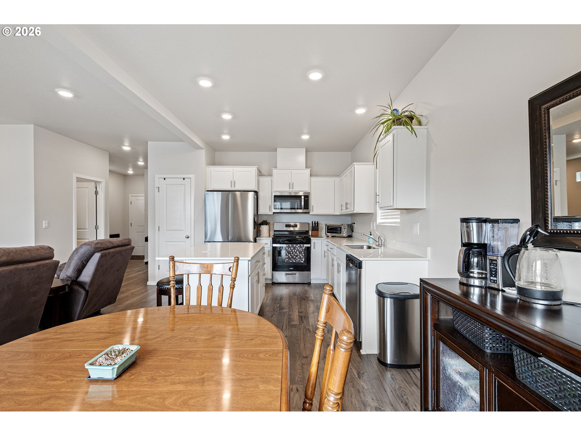 2259 30th Place Springfield, OR 97477 - Photo 22 of 48 a kitchen with stainless steel appliances kitchen island granite countertop a table chairs and a refrigerator