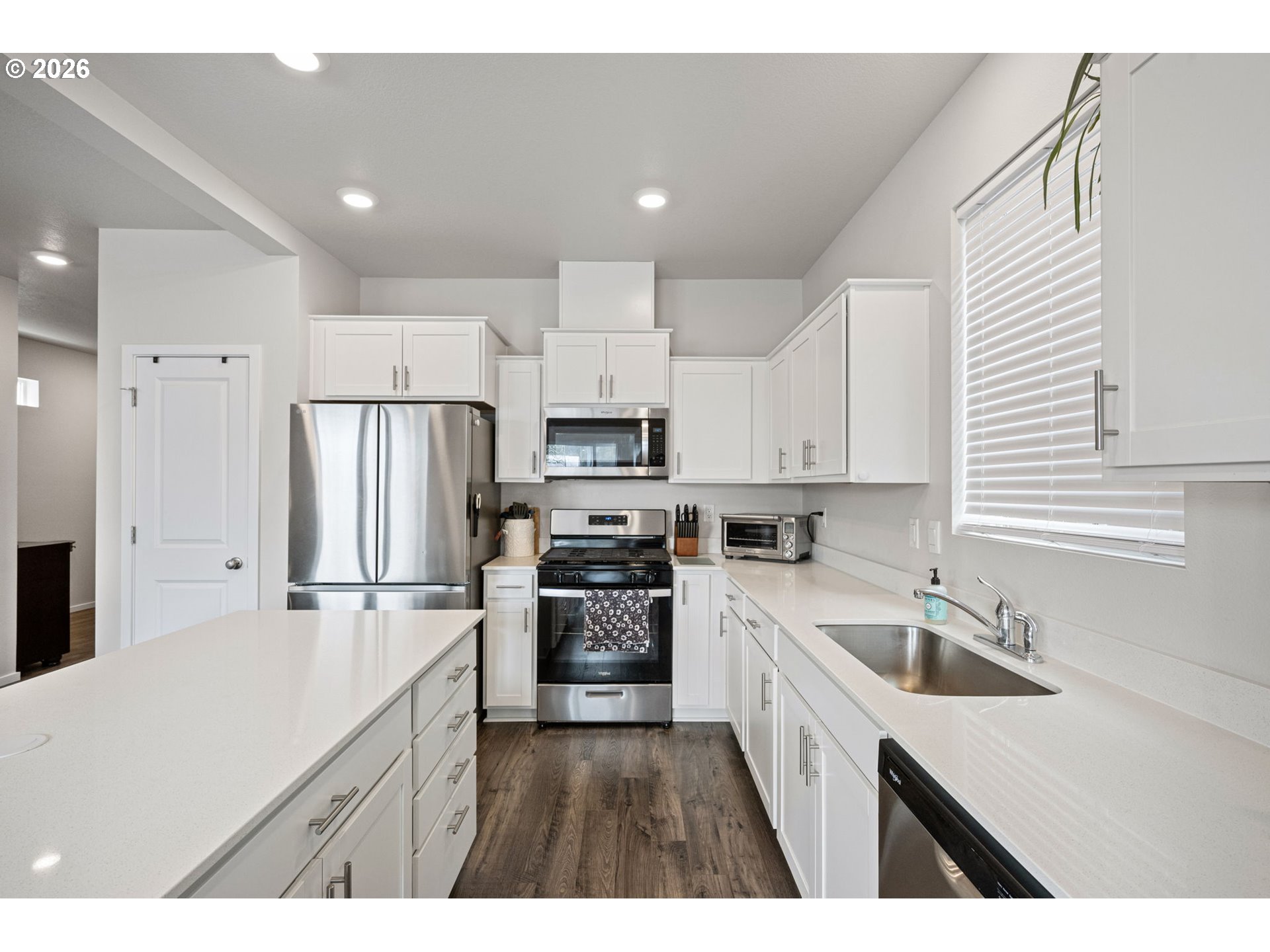 2259 30th Place Springfield, OR 97477 - Photo 23 of 48 a kitchen with kitchen island a sink stove and refrigerator
