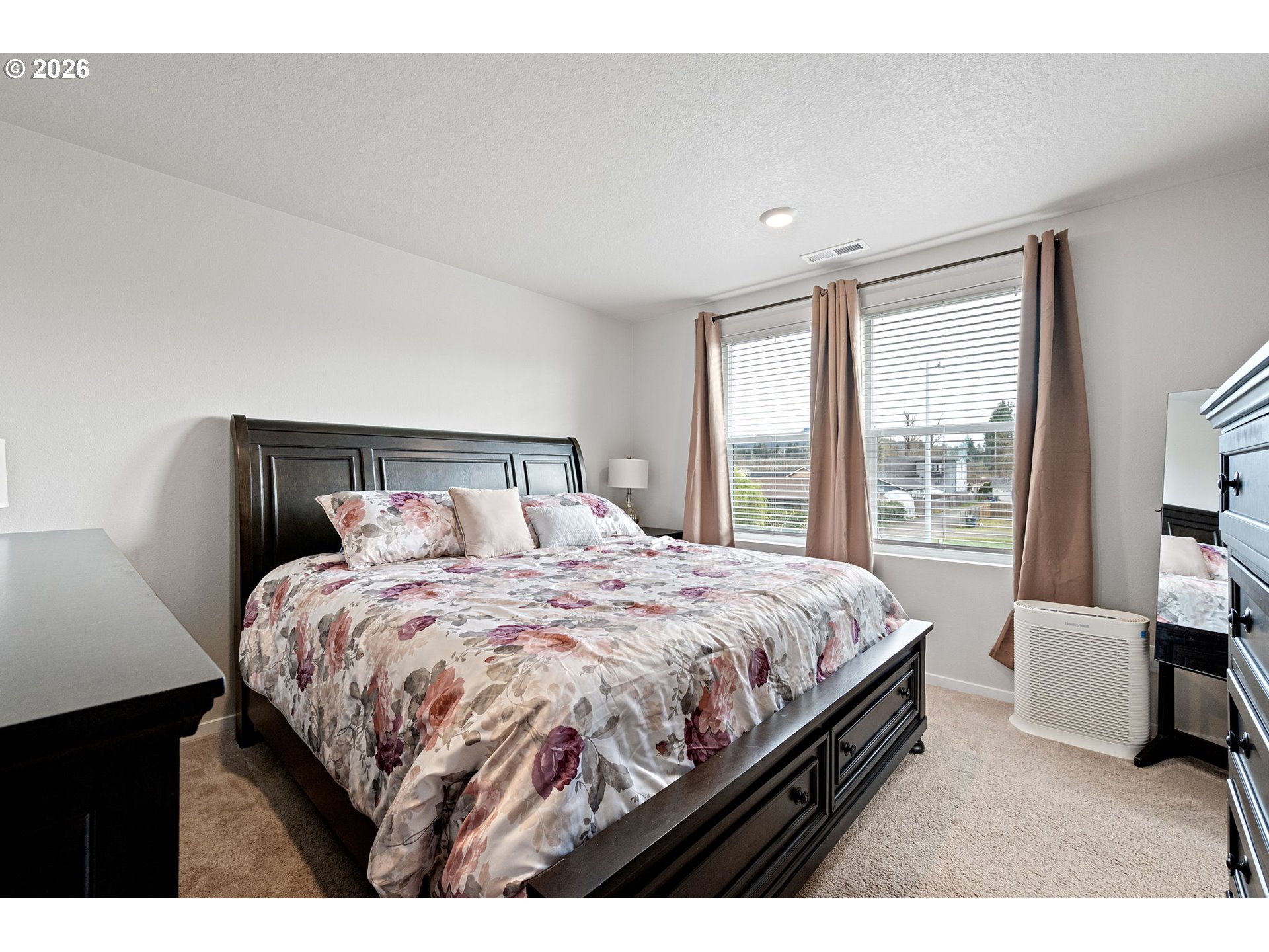 2259 30th Place Springfield, OR 97477 - Photo 29 of 48 a bedroom with a bed a large mirror and a large window