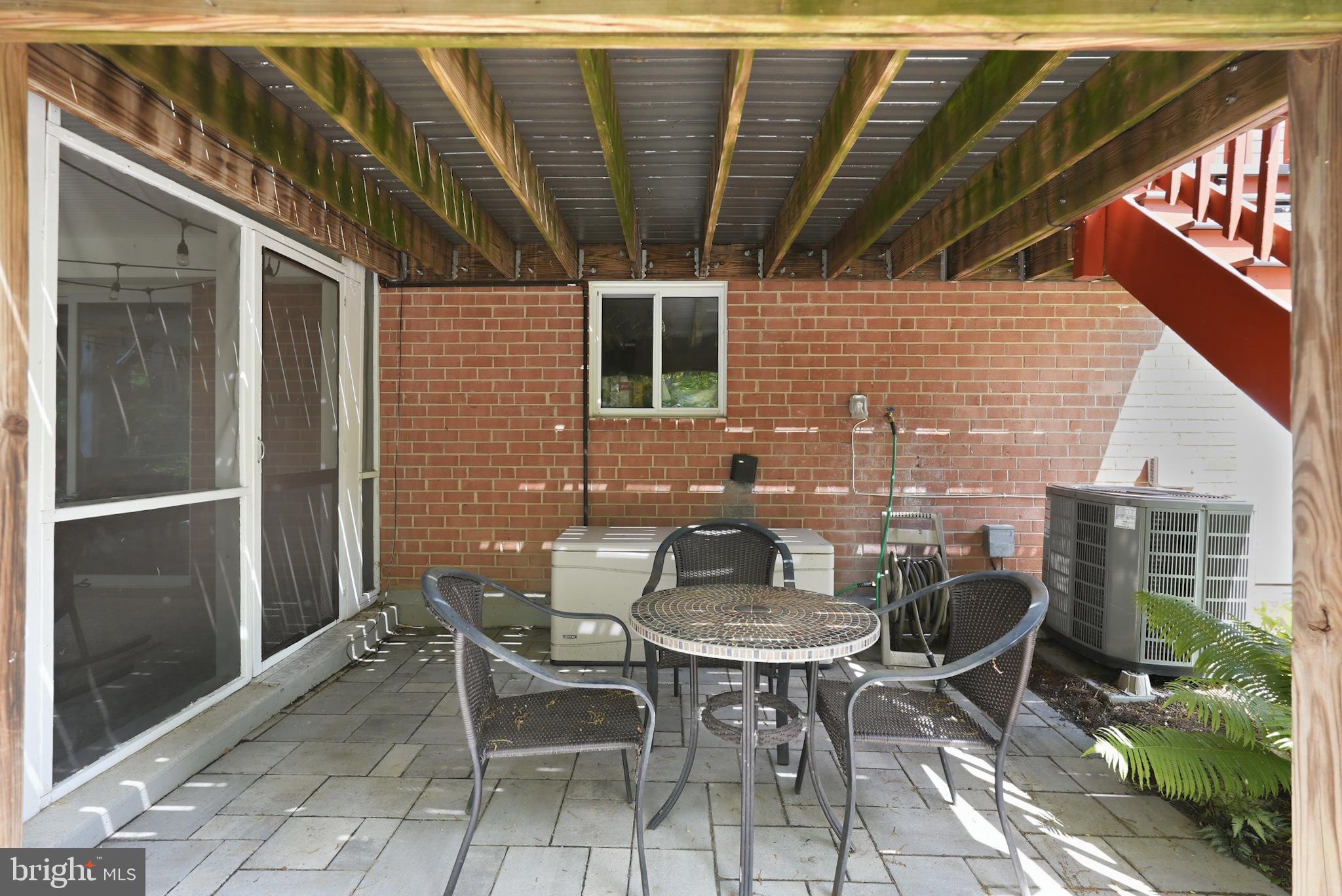 7006 Barnack Drive Springfield, VA 22152 - Photo 44 of 56 a backyard of a house with table and chairs