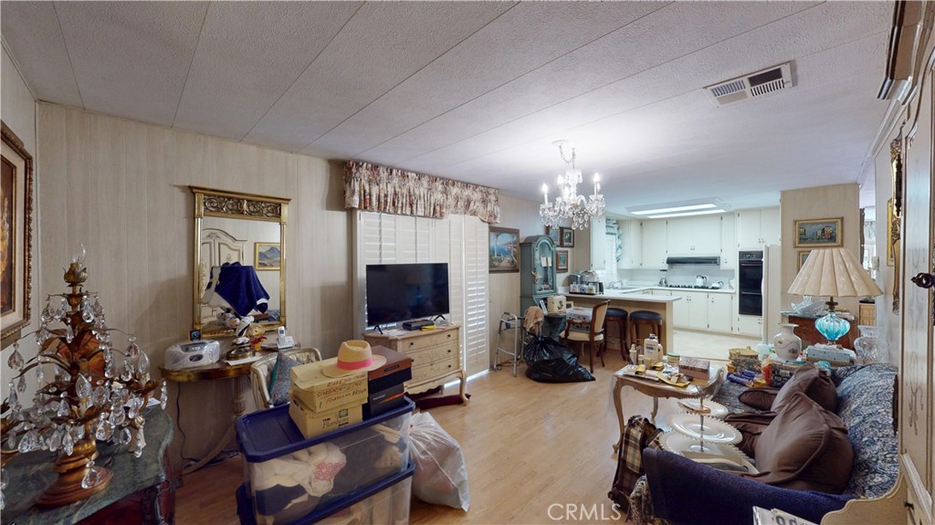 14851 Jeffrey Road, Unit 117 Irvine, CA 92618 - Photo 23 of 45 a living room with furniture a fireplace and a flat screen tv