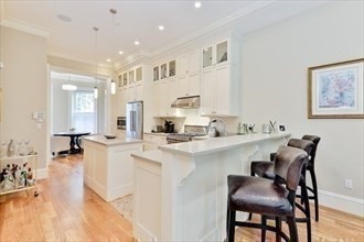 a large white kitchen with furniture and a table