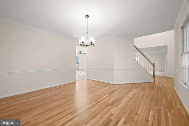 a kitchen with granite countertop white cabinets and stainless steel appliances