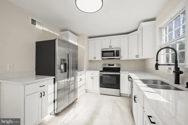 a view of empty room with a fireplace