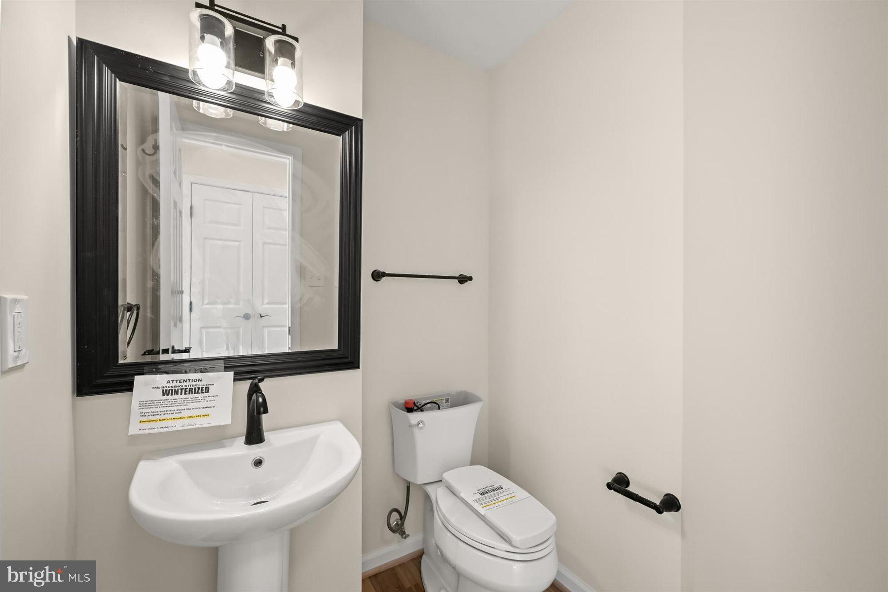 13121 Old Fletchertown Road Bowie, MD 20720 - Photo 23 of 91 a bathroom with a sink a toilet and mirror