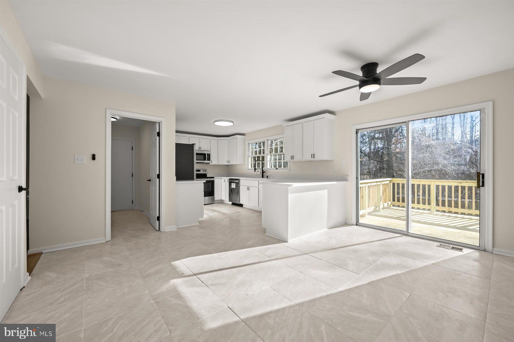 13121 Old Fletchertown Road Bowie, MD 20720 - Photo 24 of 91 a large white bed in a white room with a window and a kitchen