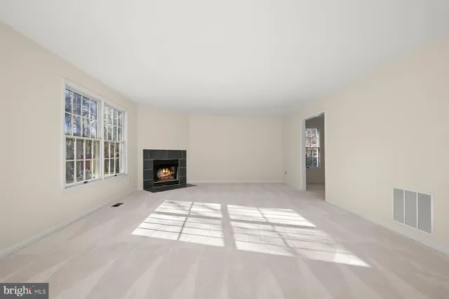 a view of an empty room and a window