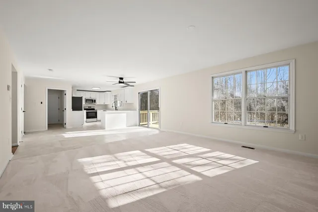a view of an empty room with a kitchen