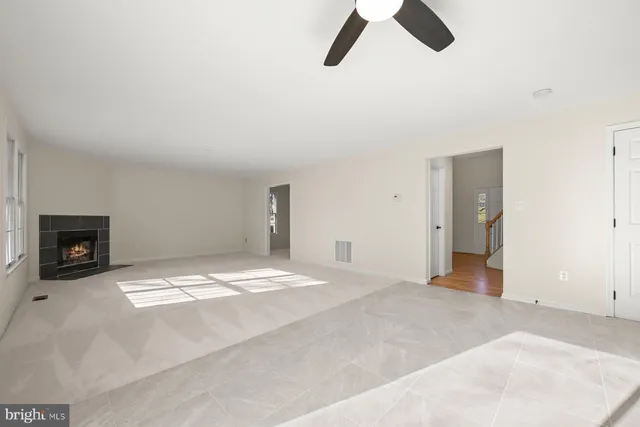 a view of an empty room with a kitchen