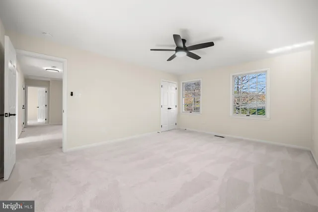 a bathroom with a granite countertop sink toilet a mirror and shower