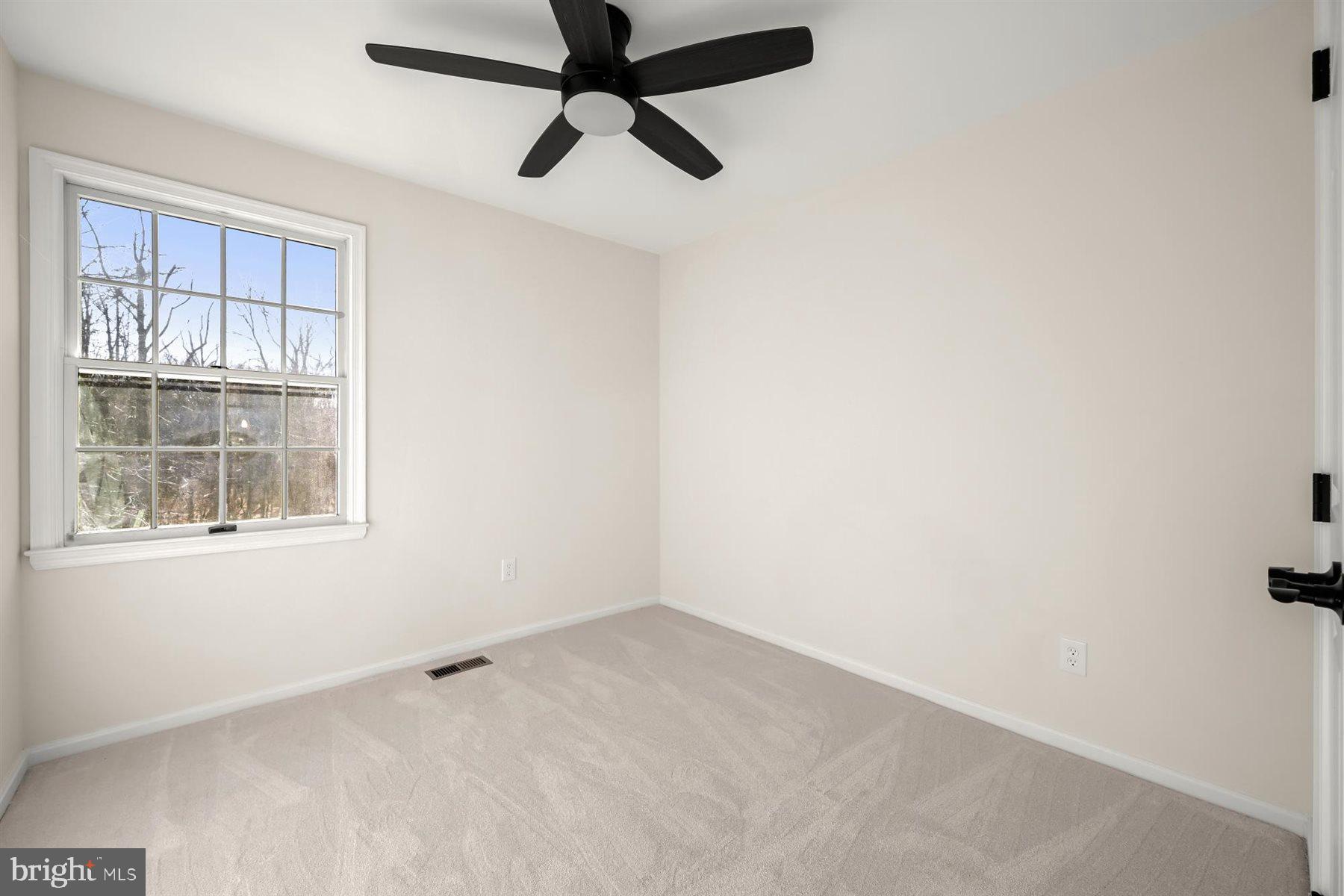13121 Old Fletchertown Road Bowie, MD 20720 - Photo 45 of 91 an empty room with a window and a fan