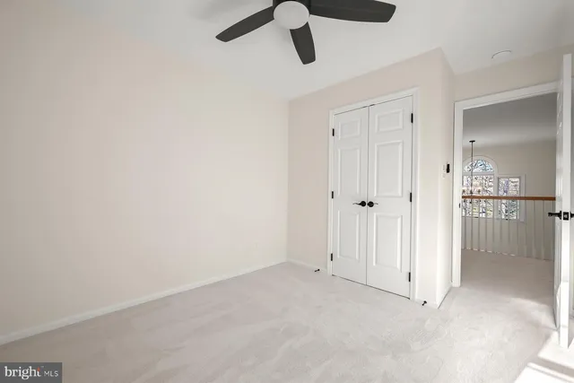 a front view of a house with a garden and trees