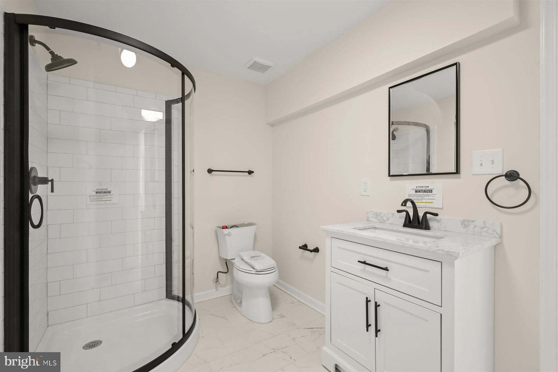 13121 Old Fletchertown Road Bowie, MD 20720 - Photo 69 of 91 a bathroom with a granite countertop sink toilet a mirror and shower