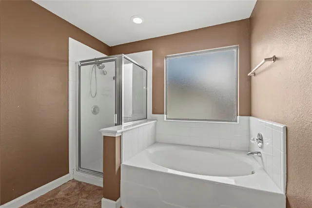 a bathroom with a tub and shower