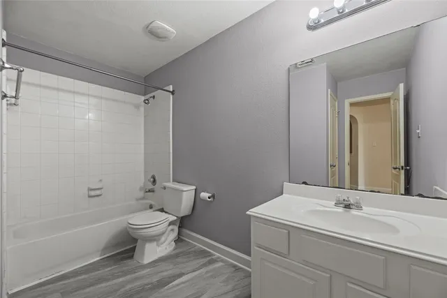 a bathroom with a double vanity sink toilet and shower