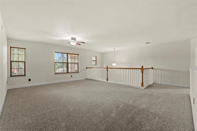 a view of a livingroom with a ceiling fan and window